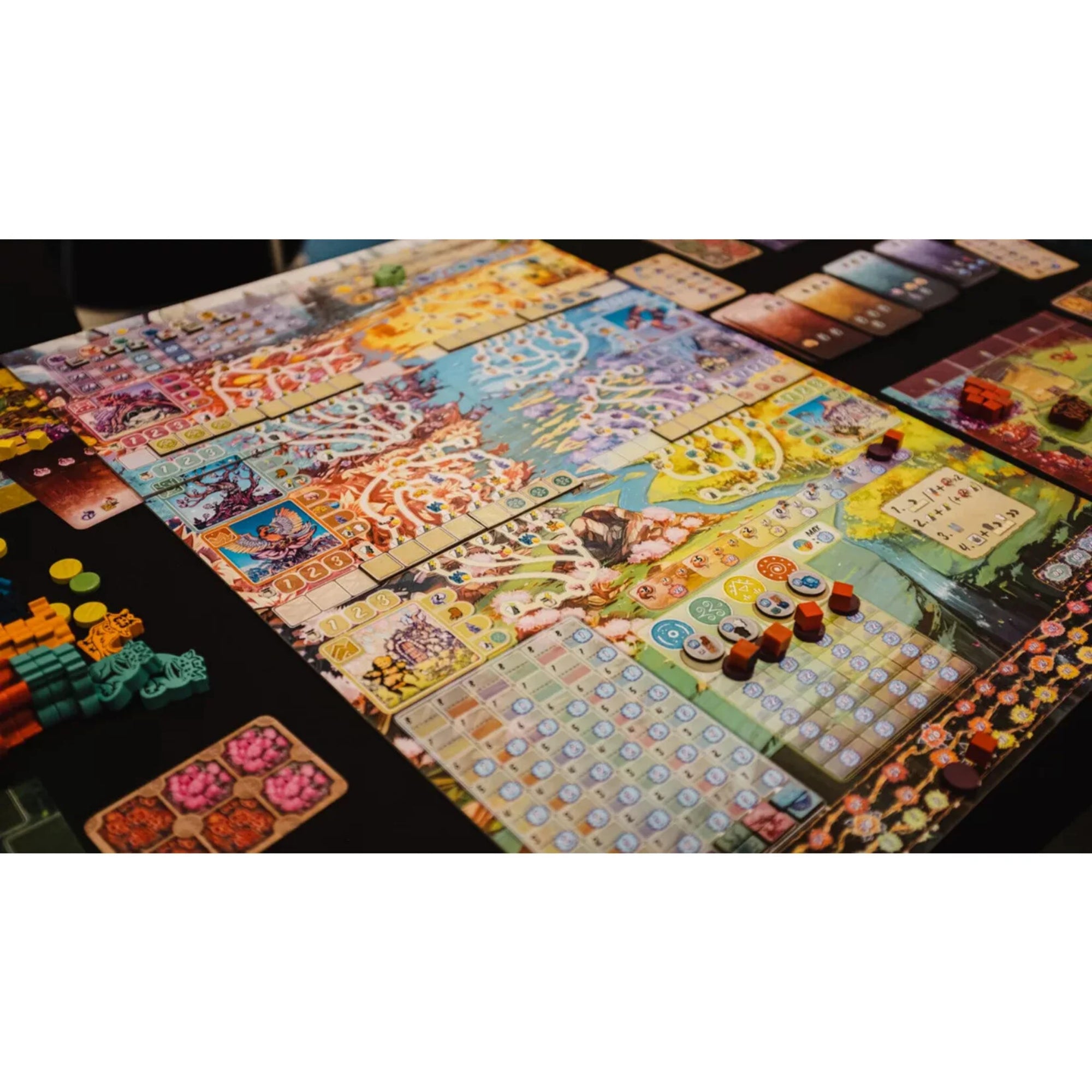 A Buru társasjáték színes, részletgazdag játéktáblája játék közben, különböző régiókkal, jelölőkkel, lapkákkal és fa komponensekkel elrendezve az asztalon.