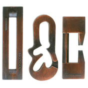 A Huzzle Cast VIOLON három különálló bronzszínű darabja szétszedve, köztük a jellegzetes "VIOLON" feliratú elem.