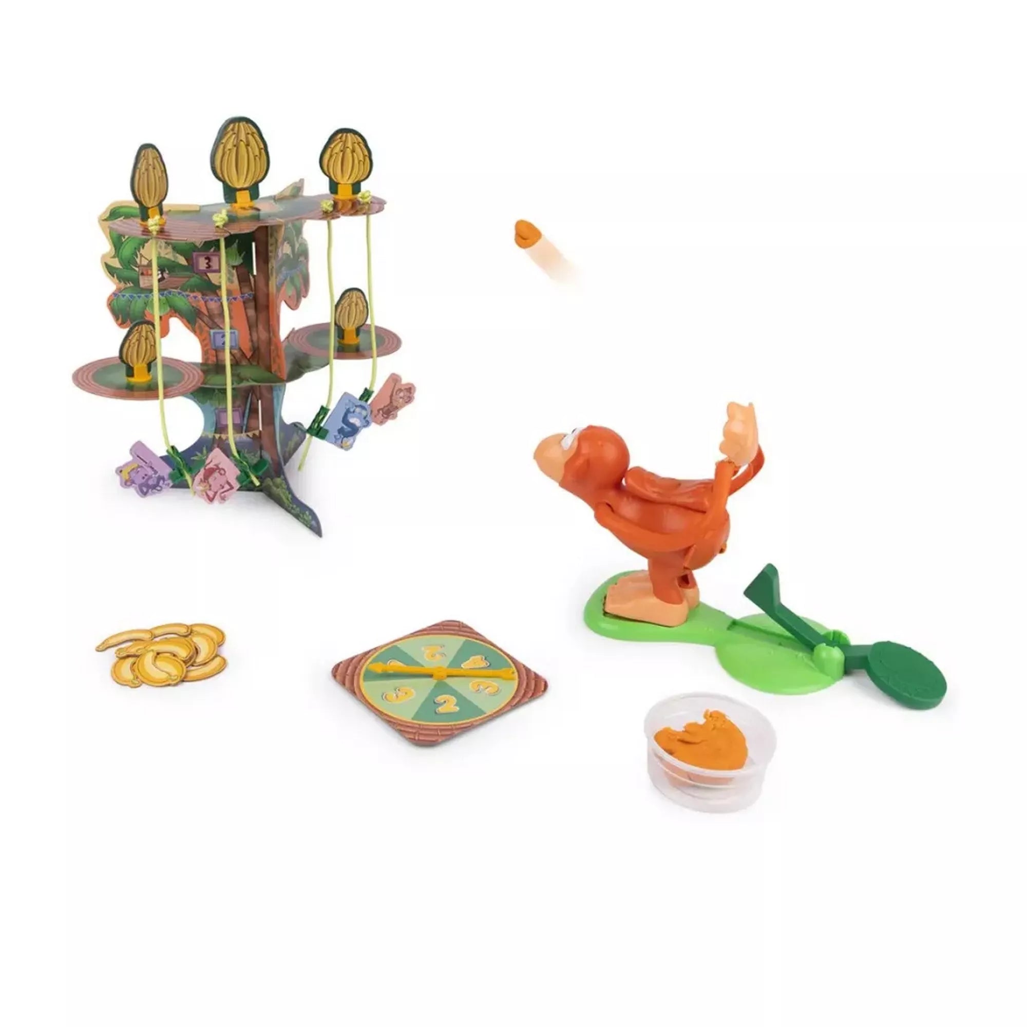 A Monkey See Monkey Poo társasjáték akció közben, ahol a majom figura a célpontok felé „dobja” a játékdarabot, a háttérben a felépített pálmafás játéktáblával és kiegészítőkkel.