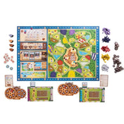 A Windmill Valley társasjáték teljes tartalma kiterítve: középen a játéktábla, körülötte fogaskerekek, játékos táblák, színes jelölők és egyéb kiegészítők.