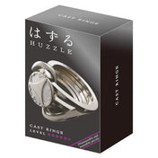 A Huzzle Cast RING II doboza elegáns fekete háttérrel, rajta a kirakó képe és a nehézségi szintet jelző öt csillag.