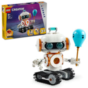 A LEGO Creator 31164 Űrrobot csomag tartalmaz egy hófehér, gördülő láncokon mozgó robotot, nagy, kerek szemekkel, egy lámpával, amely a mellkasában világít, és egy kézben tartott, kék balon formájú tárggyal. A háttérben látható a csomagolás, amely az építőkészlet többi változatát is bemutatja.