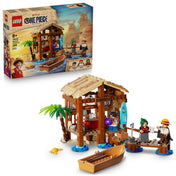 A LEGO One Piece: Windmill Village Hut (75636) doboza és az összerakott tengerparti kunyhó építmény Monkey D. Luffy, Shanks és Makino minifiguráival, csónakkal és pálmafával.