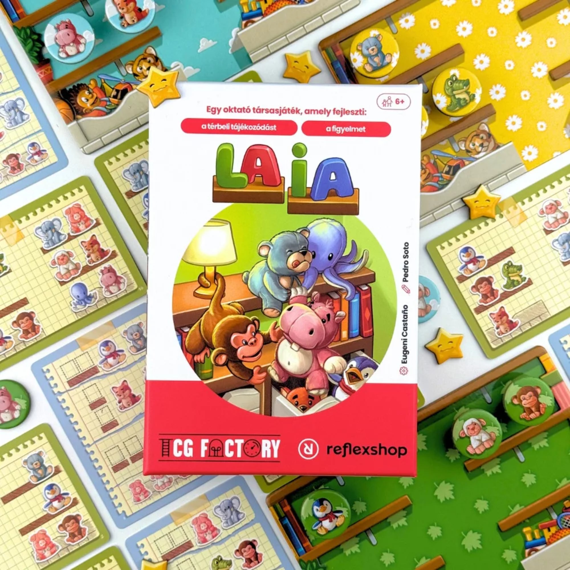 Laia társasjáték doboza felülről fotózva, körülötte a játék állatos korongjai, játéktáblái és feladatkártyái.