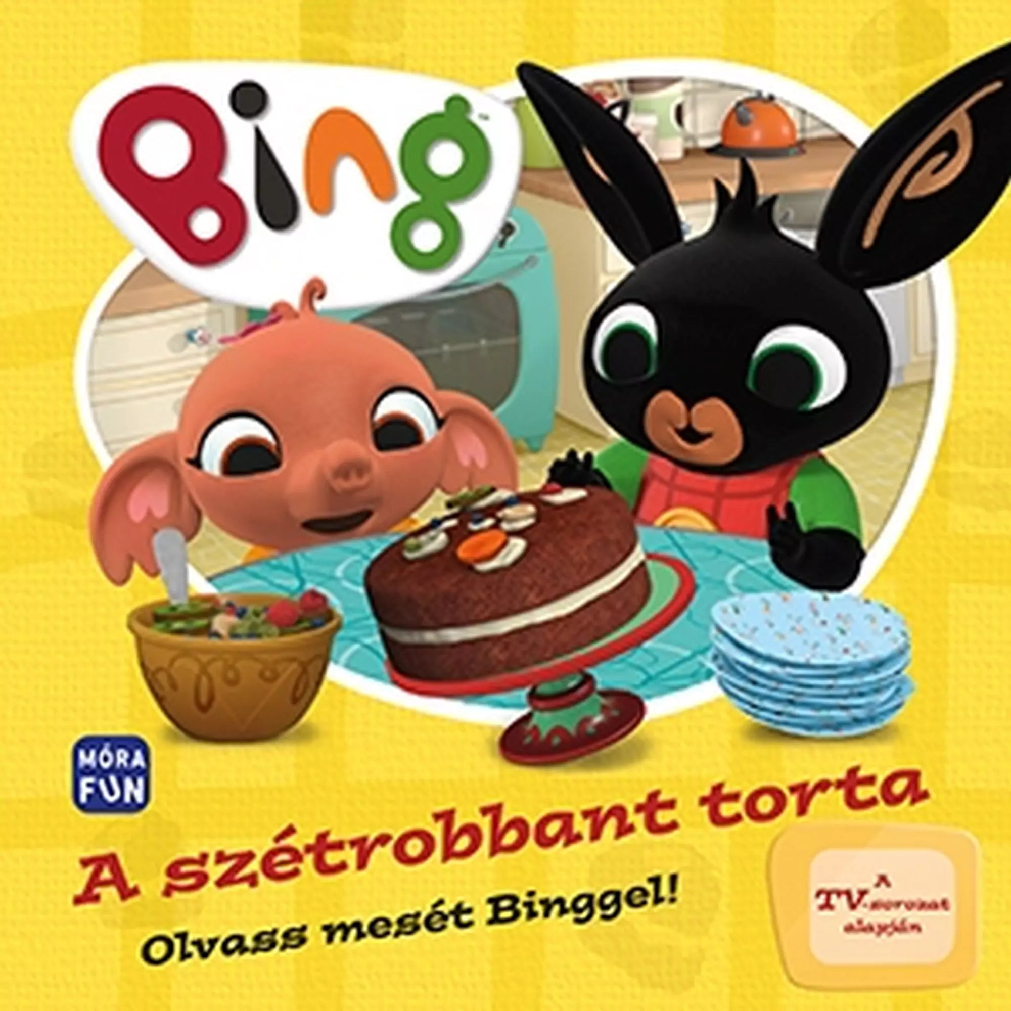 A szétrobbant torta című gyerekkönyv borítója, amelyen Bing és Sula egy asztalnál ülnek egy csokoládétorta mellett. A háttérben konyhai jelenet látható, a borítón szerepel a Móra Kiadó logója és a „TV-sorozat alapján” felirat is.