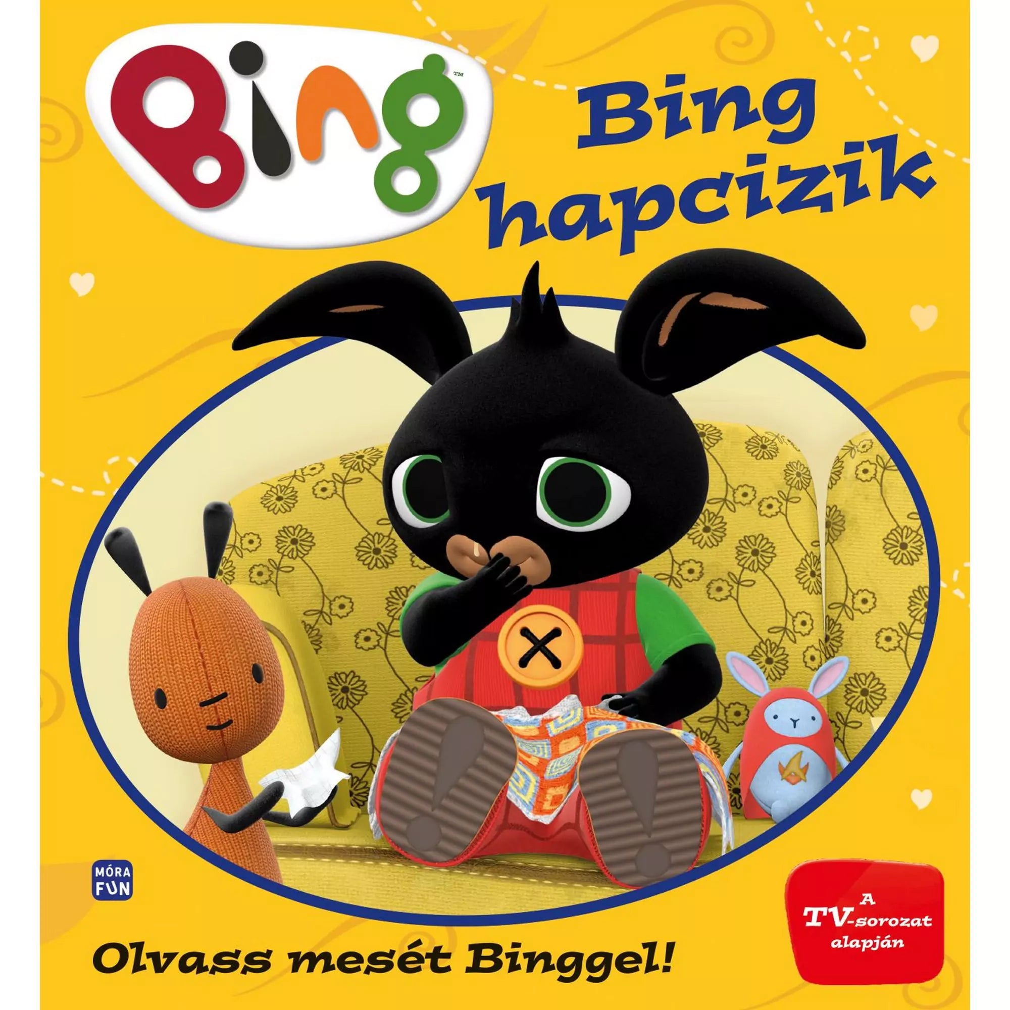 „Bing hapcizik” borítója – a könyv közepén Bing, a fekete nyuszi zsebkendővel az orrán ül egy virágmintás kanapén, mellette Flop és egy kék plüssnyuszi.