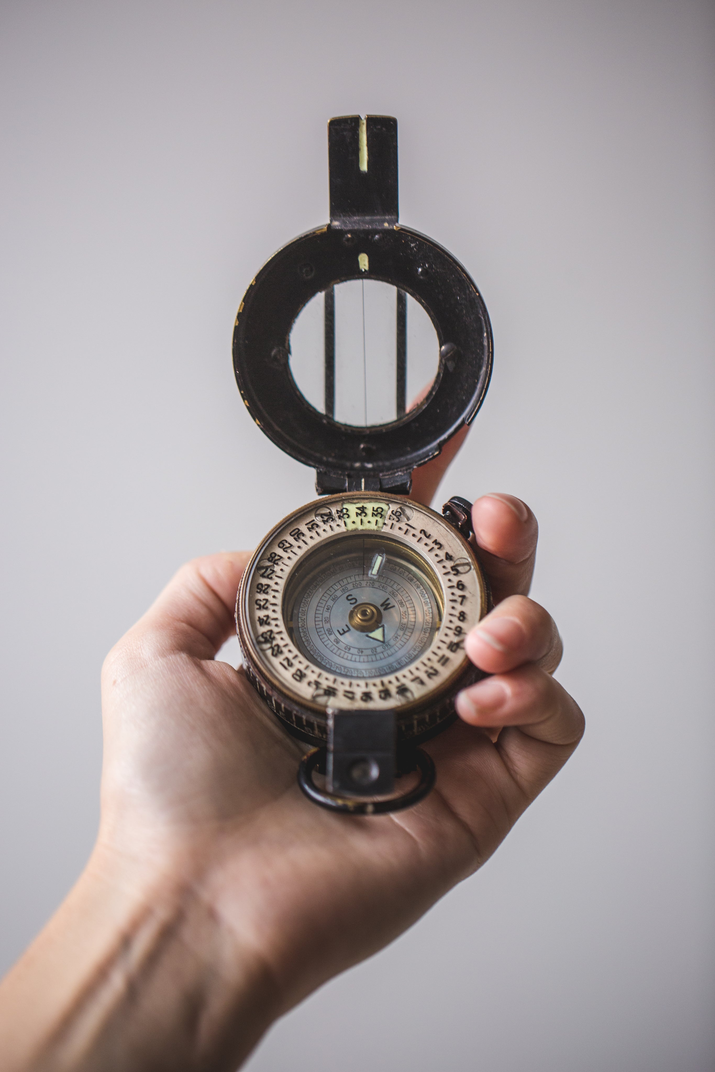 close-up-of-hand-holding-compass.jpg