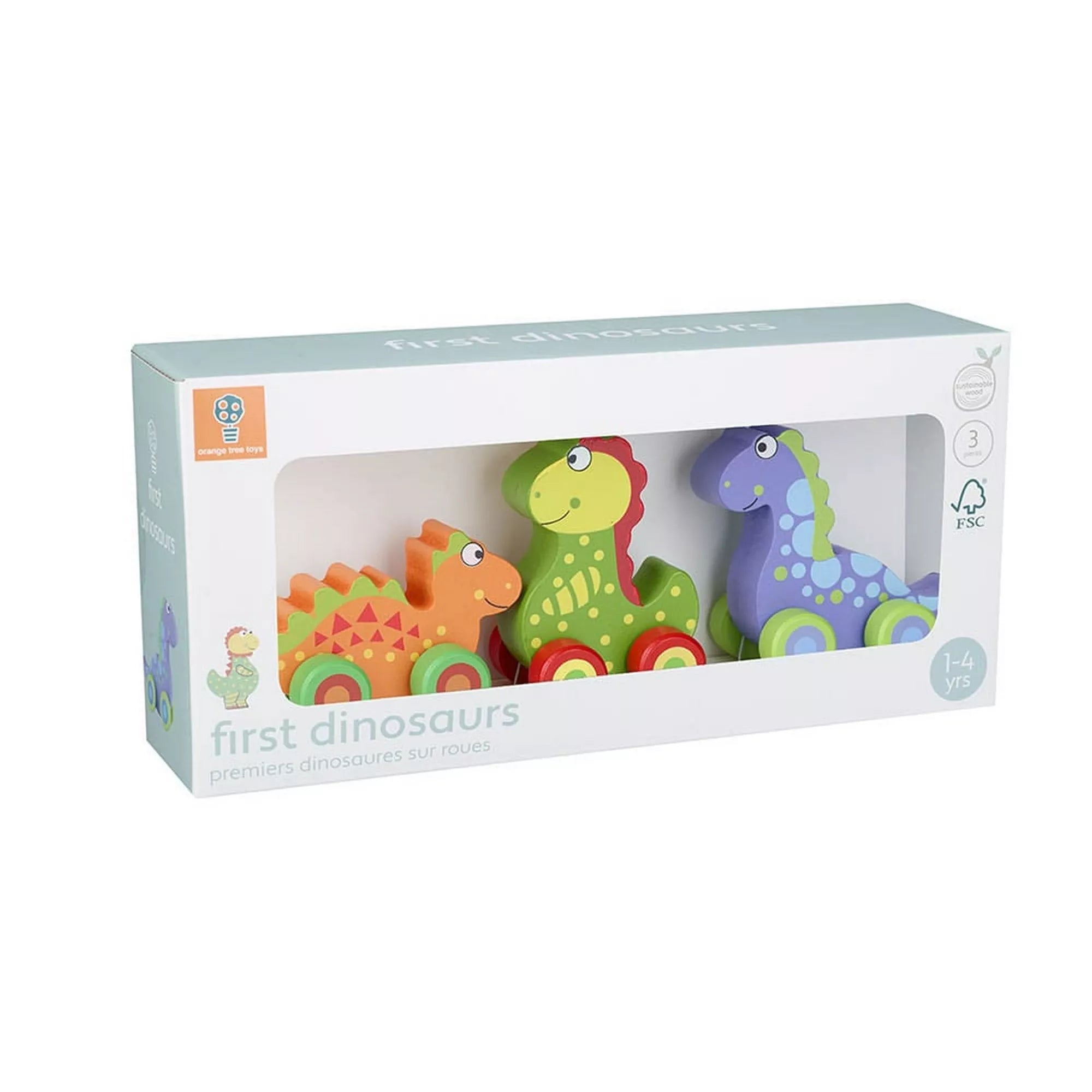 Az Orange Tree Toys „Első dinoszauruszaim” fa játékkészlet doboza, benne három színes, kerekes dinoszaurusszal – narancs, zöld és kék színben, 1–4 éveseknek ajánlva.