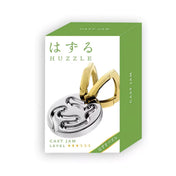 Huzzle Cast JAM puzzle zöld dobozban, japán Huzzle felirattal és a logikai játék illusztrációjával.