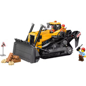  LEGO City: Sárga buldózer 60466 játékjelenet, a buldózer elölről látható, előtte fahasábok és egy figyelmeztető tábla.