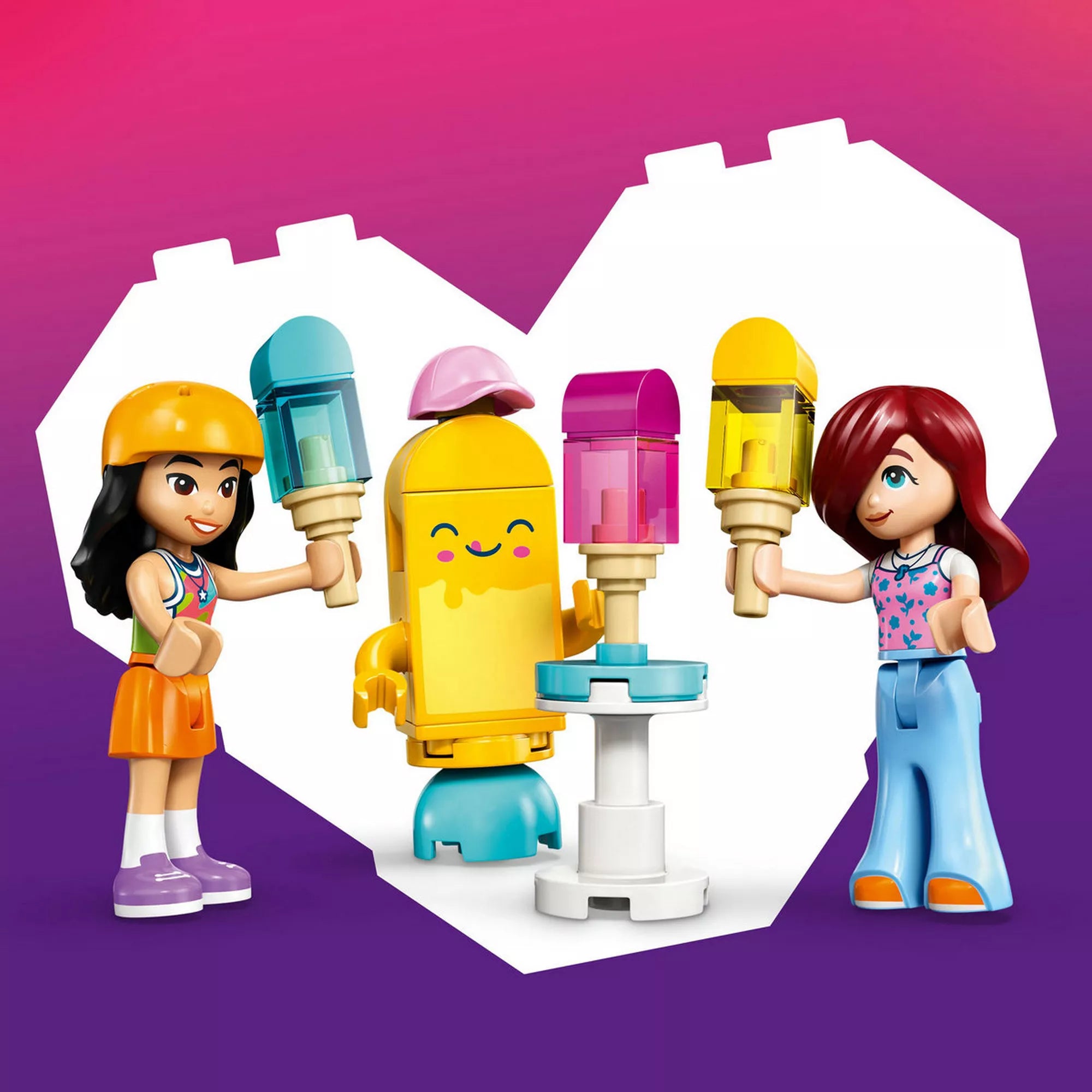 LEGO Friends Liann és Paisley minifigurák a fagylalt alakú kabalafigurával, kézben tartott fagylaltokkal és állítható asztallal, szív alakú háttér előtt.
