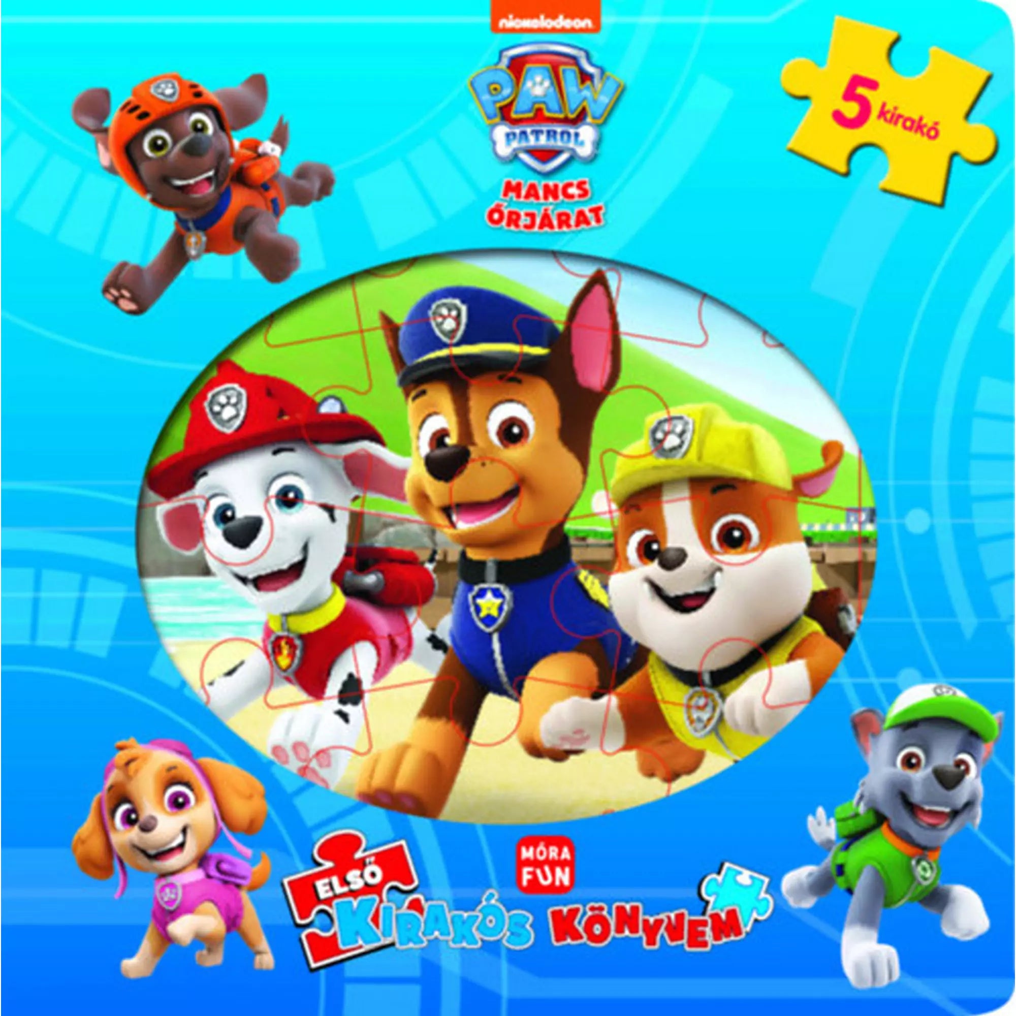 Mancs Őrjárat: Első kirakós könyvem borítója, amelyen Zuma, Marshall, Chase, Rubble, Skye és Rocky vidáman pózolnak a tengerparton, színes puzzle-elemekkel.