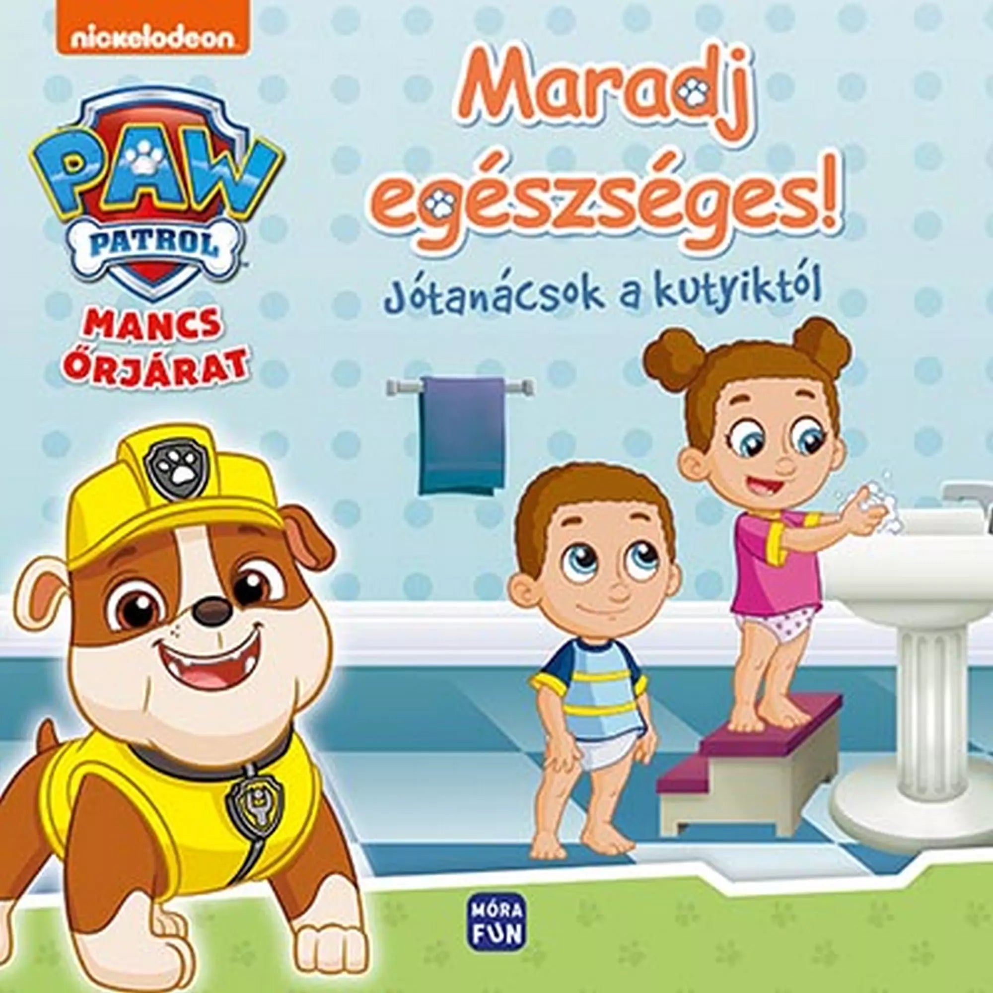„Maradj egészséges! – Jótanácsok a kutyiktól” című Mancs Őrjárat könyv borítója, amelyen Rubble kutya mosolyog, mellette egy kisfiú és egy kislány látható, amint kézmosást gyakorolnak a fürdőszobában.