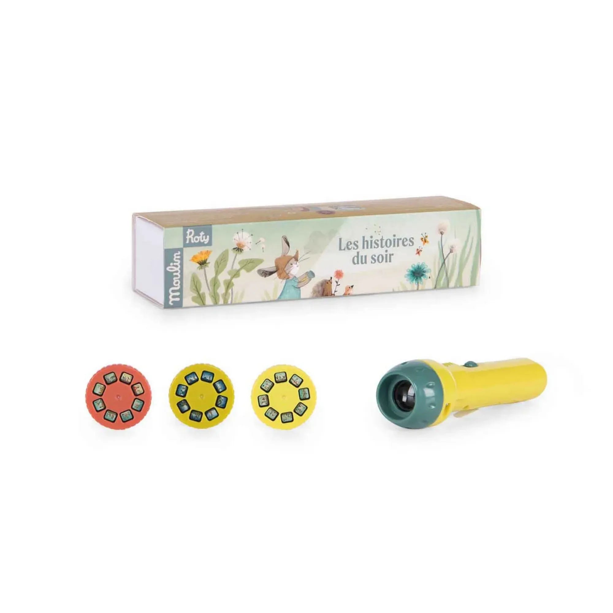 Moulin Roty meselámpa: A három nyuszi sárga mesélő vetítője állítva, előtte három színes diahengerrel és a mintás dobozzal.