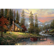 Thomas Kinkade erdei tájkép puzzle képe: faház, patak, tóparti csónak és hegyvidéki fenyves naplementében.